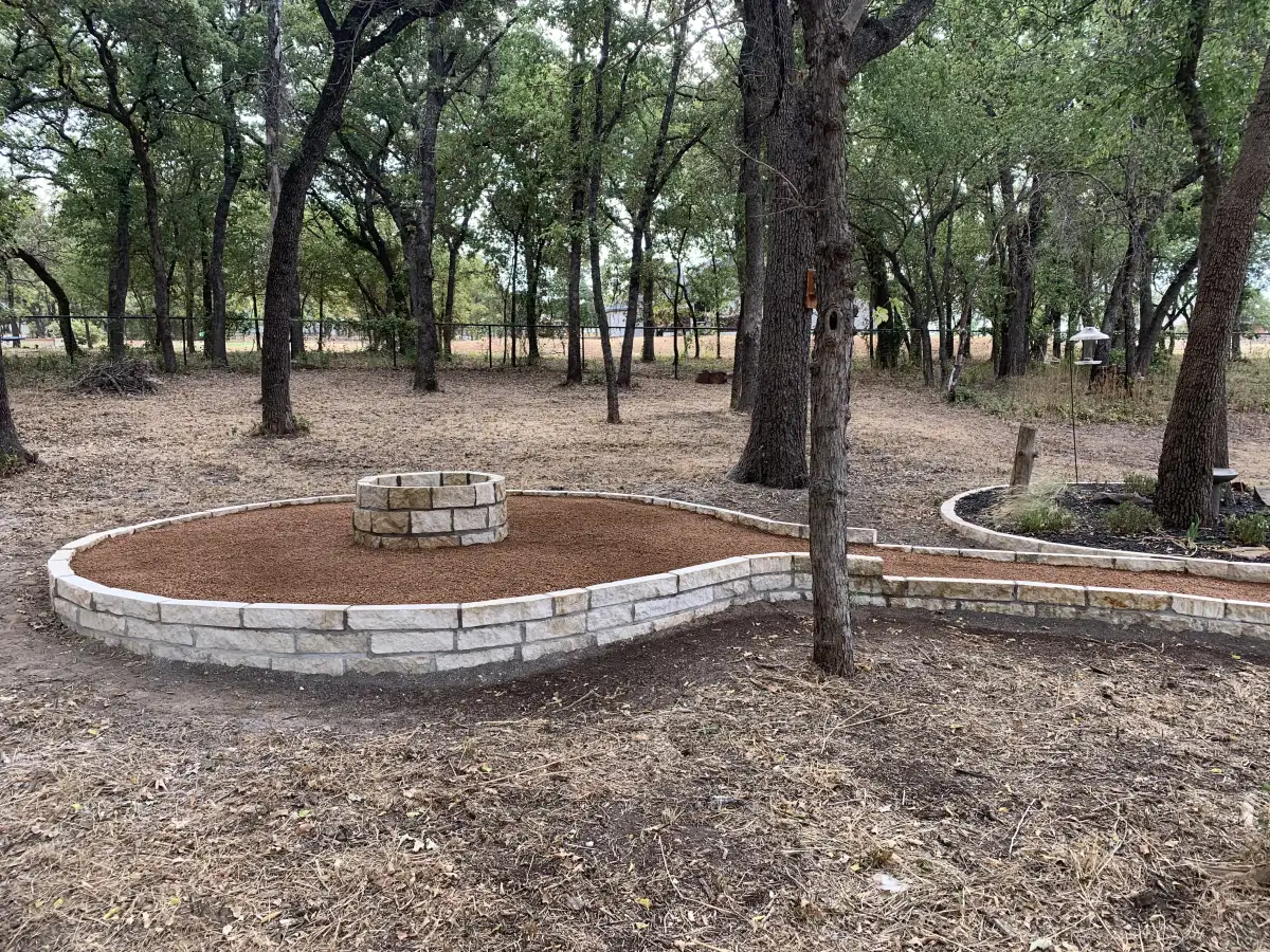 Custom stone fire pit with retaining wall in Weatherford TX